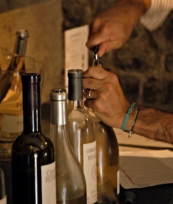 Photo of Alban opening wine bottles for our tasting